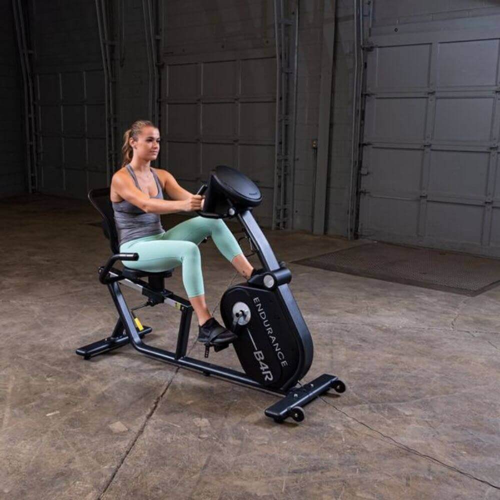 Body-Solid Endurance Recumbent Bike B4RB - front view of the product with woman using the machine