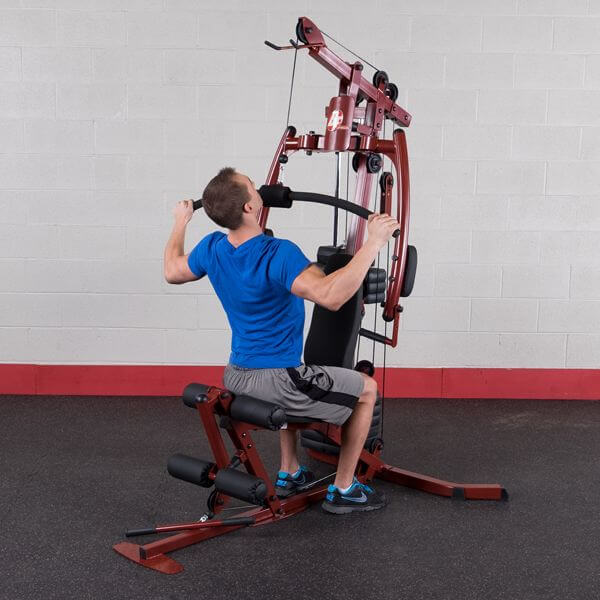 Best Fitness BFMG20 Sportsman Gym 20 - man sitting facing in front of the product white holding pec dec station 