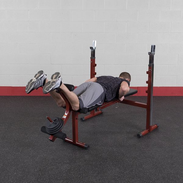 Best Fitness BFOB10 Olympic Bench With Leg Developer - man leaning and facing towards bench to workout