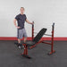 Best Fitness BFOB10 Olympic Bench With Leg Developer - man standing behind the product