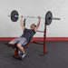 Best Fitness BFOB10 Olympic Bench With Leg Developer - Man leaning on bench with lifting heavy weights 