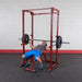 Best Fitness BFPR100 Power Rack - man on adjustable bench and squat rack 