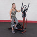 Best Fitness Cross Trainer Elliptical - woman smiling standing and stepping one foot on the actual product