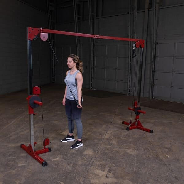 Best Fitness Plate Loaded Cable Crossover - woman on front view position doing single arm crossover on left arm