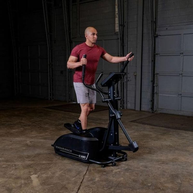 Body-Solid Endurance Center Drive Elliptical E300 - a man on an exercise machine