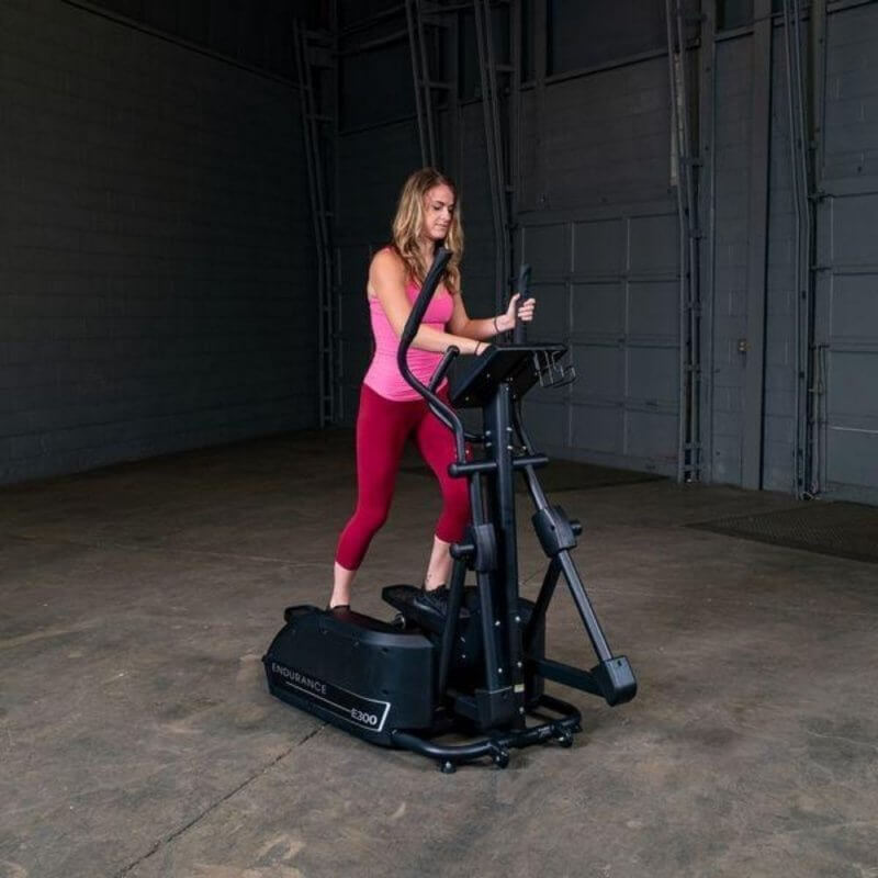 Body-Solid Endurance Center Drive Elliptical E300 - a woman on an exercise machine