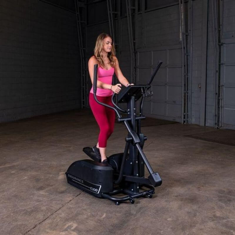 Body-Solid Endurance Center Drive Elliptical E300 - Woman in pink working out using E300