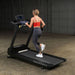 Body-Solid Endurance Commercial Treadmill T150 - back view of woman running on the equipment