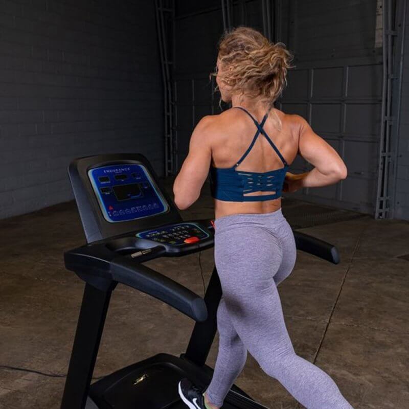 Body-Solid Endurance Folding Treadmill T25 - back photo of a woman in the treadmill. 