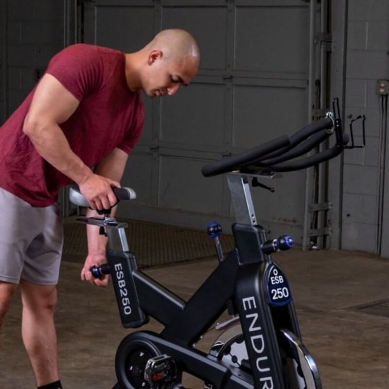 Body-Solid Endurance Spin Bike ESB250 - man adjusting the seat