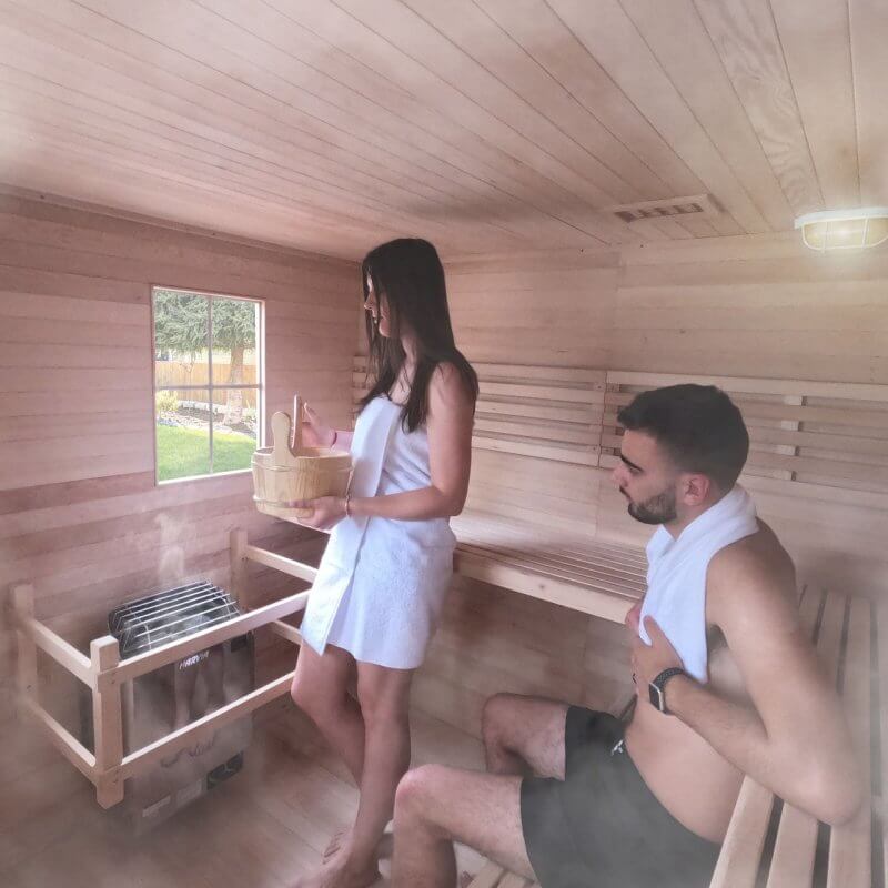 Canadian Hemlock Wet Dry Outdoor Sauna with Asphalt Roof - 8 kW UL Certified Heater - 8 Person - Man and woman inside sauna