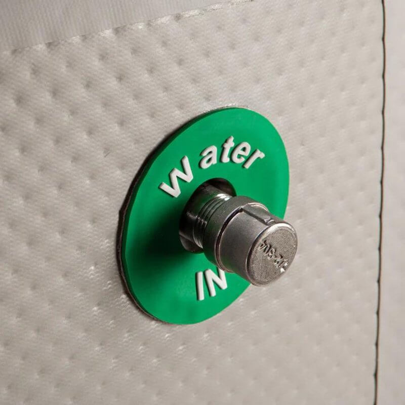 Cryospring Portable Ice Bath - a green and white button with a round metal knob