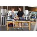 Game Ready Ice Machine GRPro 2.1 Compression Unit - A man sitting on a table with compression unit on his leg talking to another man