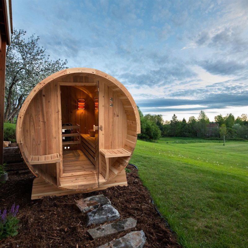 Outdoor Rustic Cedar Barrel Steam Sauna - photo of sauna taken outside with front view and lights on 