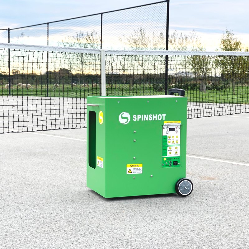 Spinshot Plus-2 Tennis Ball Machine - outdoors next to a net