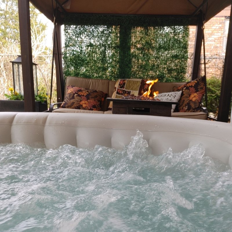 Square Inflatable Jetted Hot Tub with Cover - a picture taken inside the tub with view in balcony